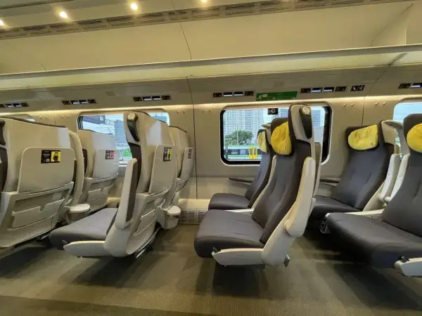 Wnętrze pociągu Pendolino. Fotele klasy 1 i 2, wygodne, z żółtymi zagłówkami, czekają na pasażerów.